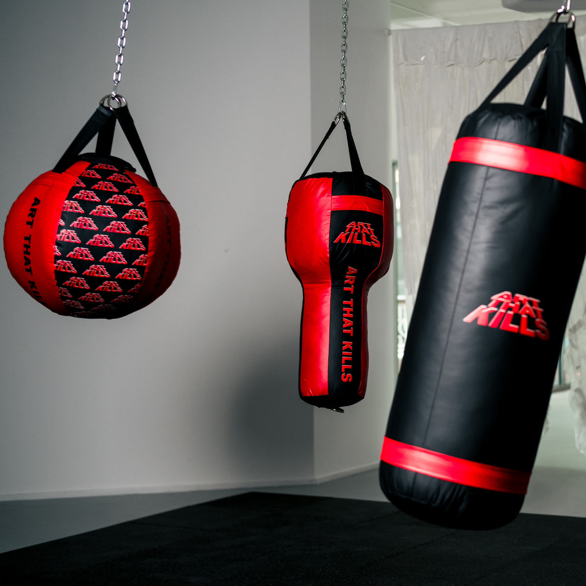 Custom heavy bags made for a client: a wrecking ball, an uppercut bag and a heavy bag with their logo
