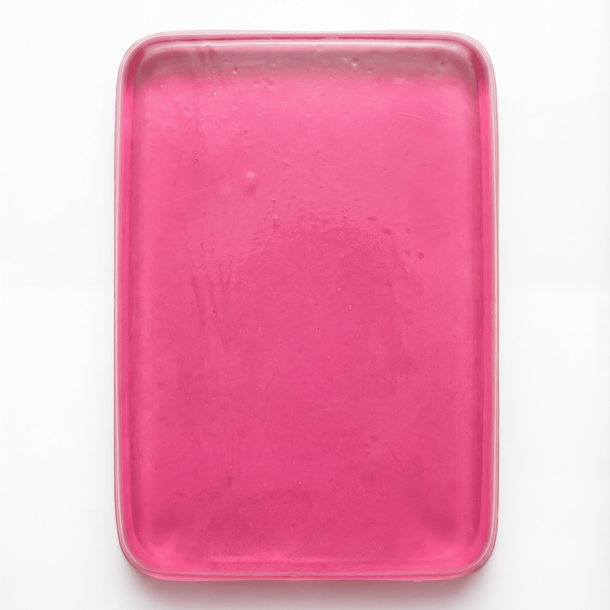 PROLAST x Skulltec gel knuckle guard in pink, a single translucent gel pad out of its pack