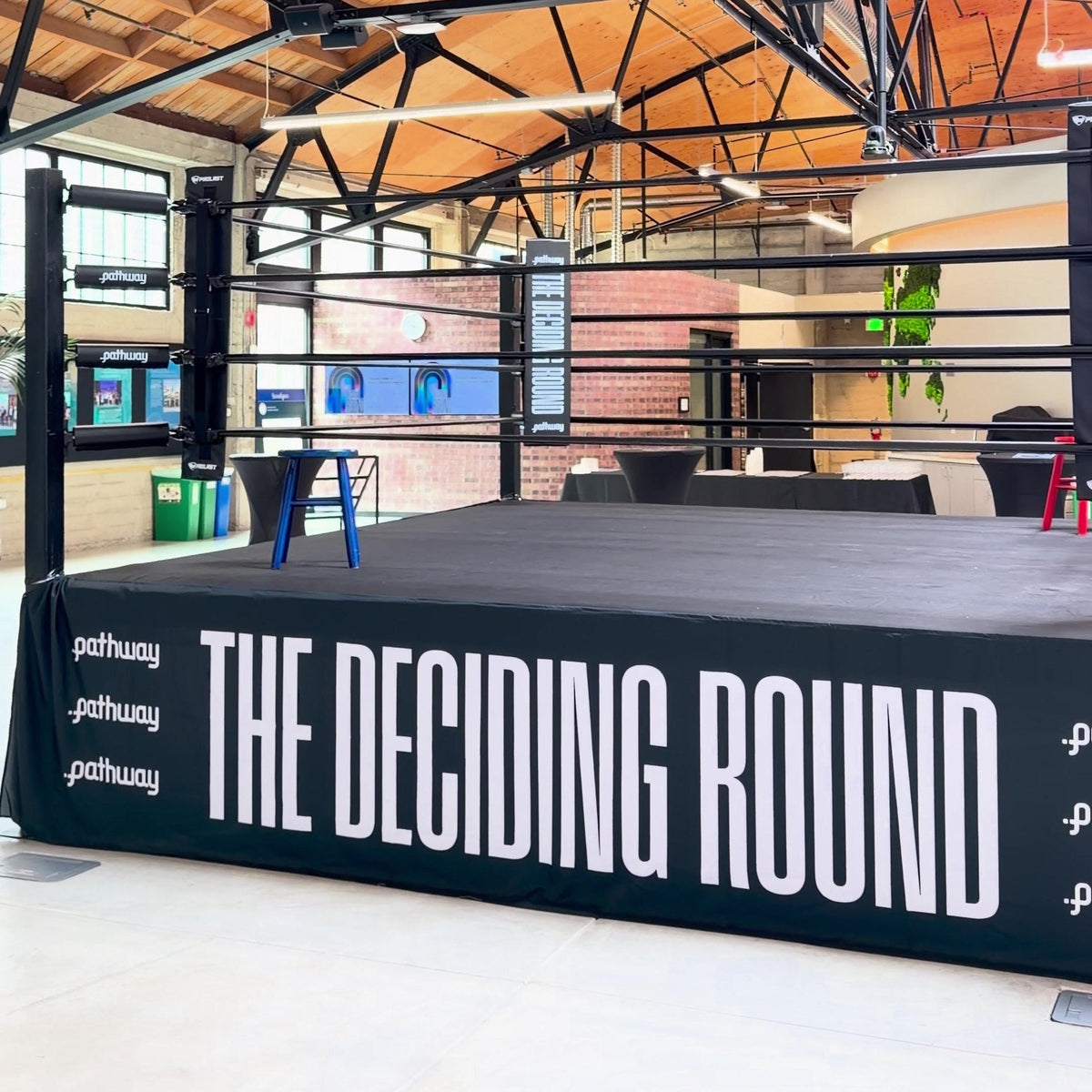 PROLAST boxing ring in an event hall with a wooden truss roof