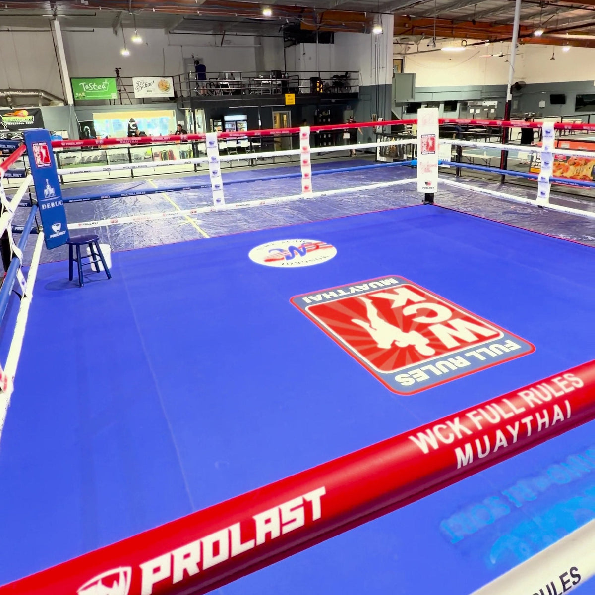 PROLAST rope cover on a Muay Thai ring with a blue canvas
