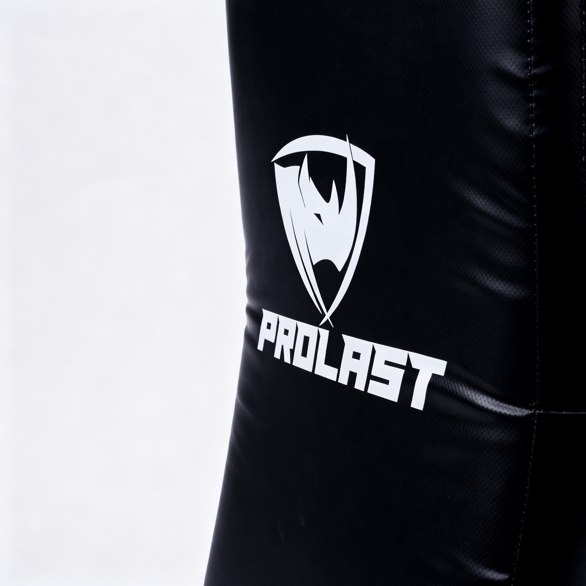 PROLAST kick shield in black, close-up of the white PROLAST rhino logo on the front