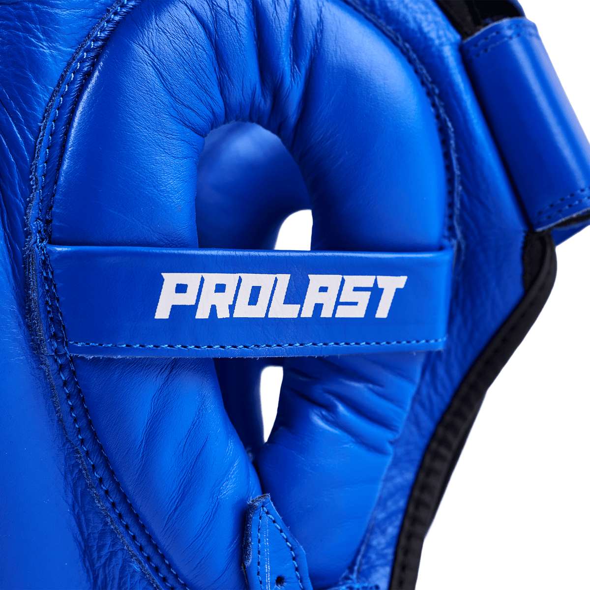 PROLAST nose bar face saver headgear in blue, close-up of the ear guard padding and white PROLAST strap