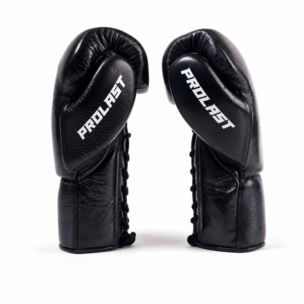 PROLAST PG professional lace-up boxing gloves in black, pair side view with white PROLAST lettering and black laces