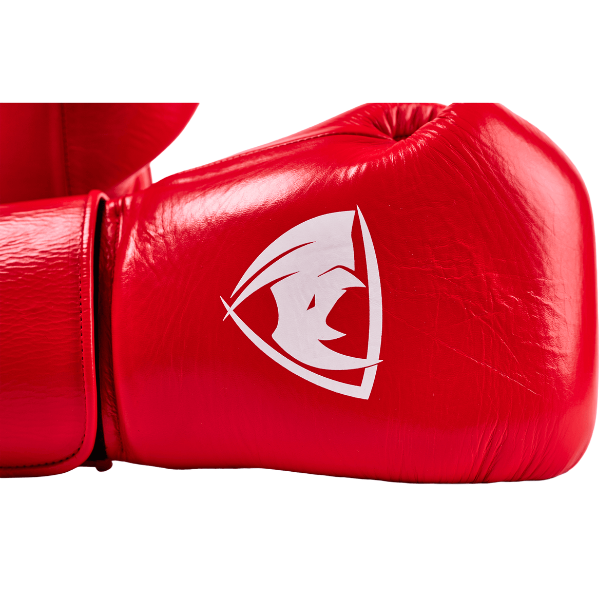 PROLAST PG professional boxing gloves in crimson red, close-up of the white rhino logo and Velcro wrist strap