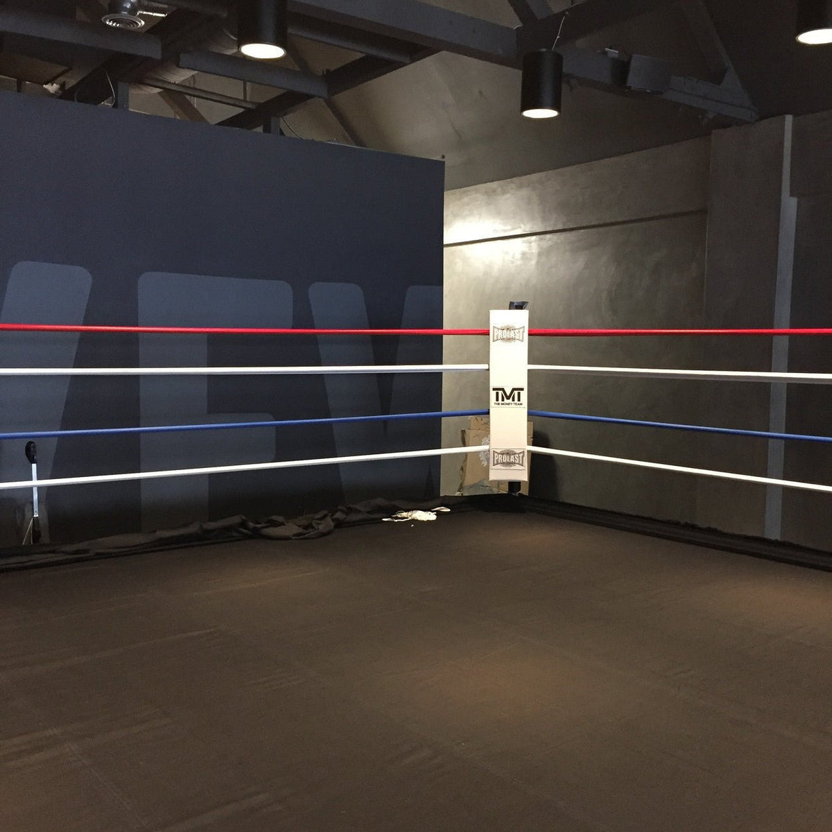 PROLAST custom corner pad with a client's logo on a boxing ring with red, white and blue ropes