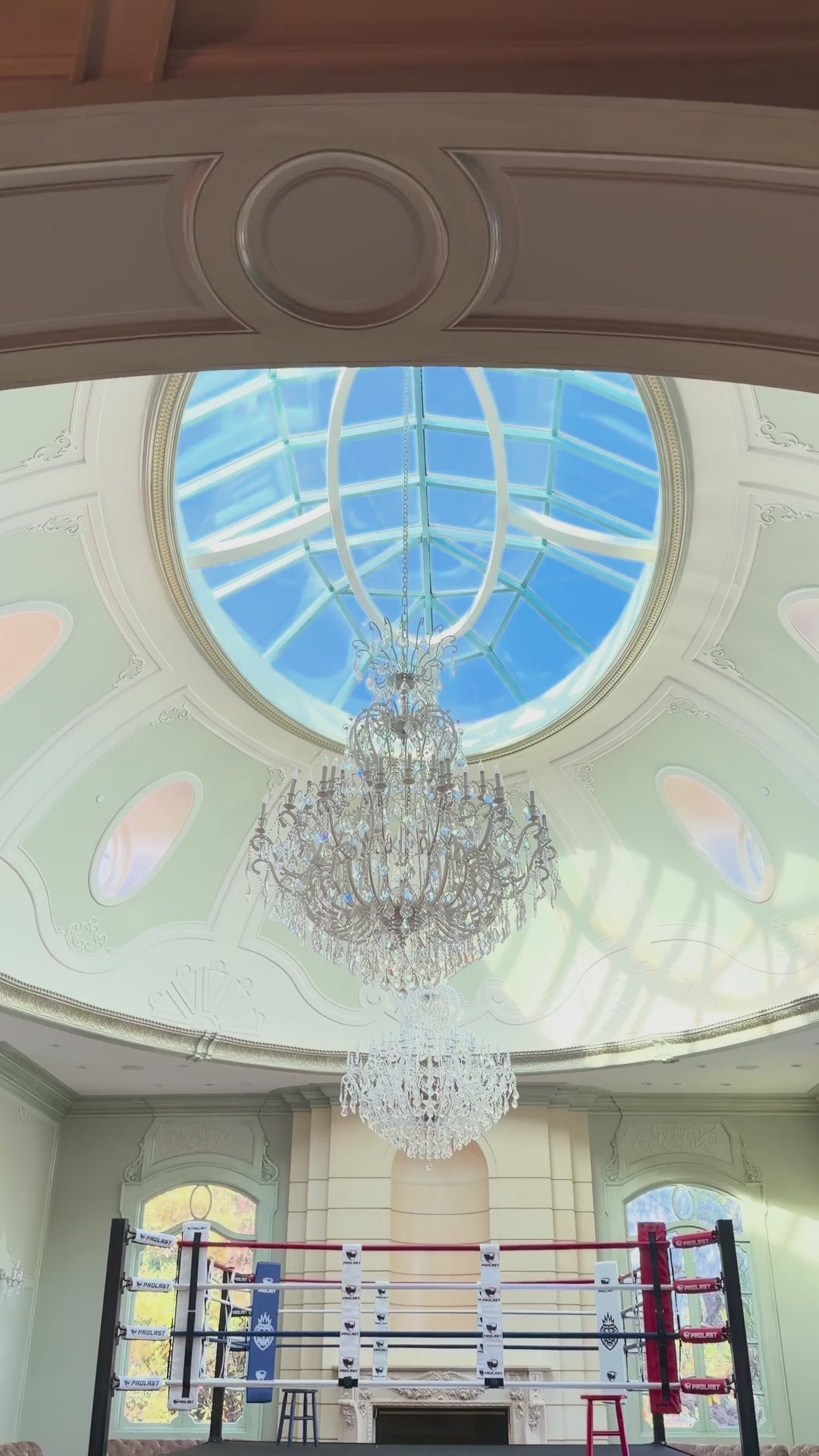 PROLAST boxing ring in a ballroom under a chandelier
