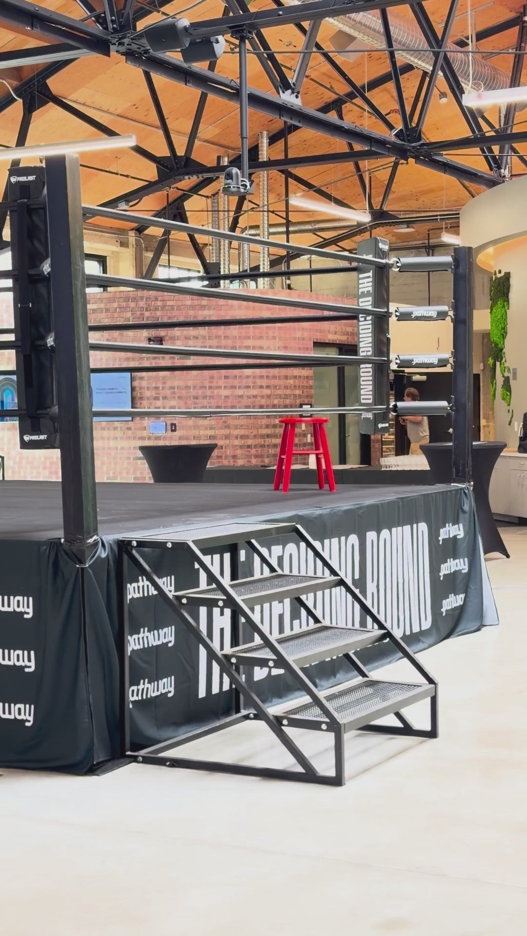 Steel stairs and corner of a PROLAST boxing ring at an event