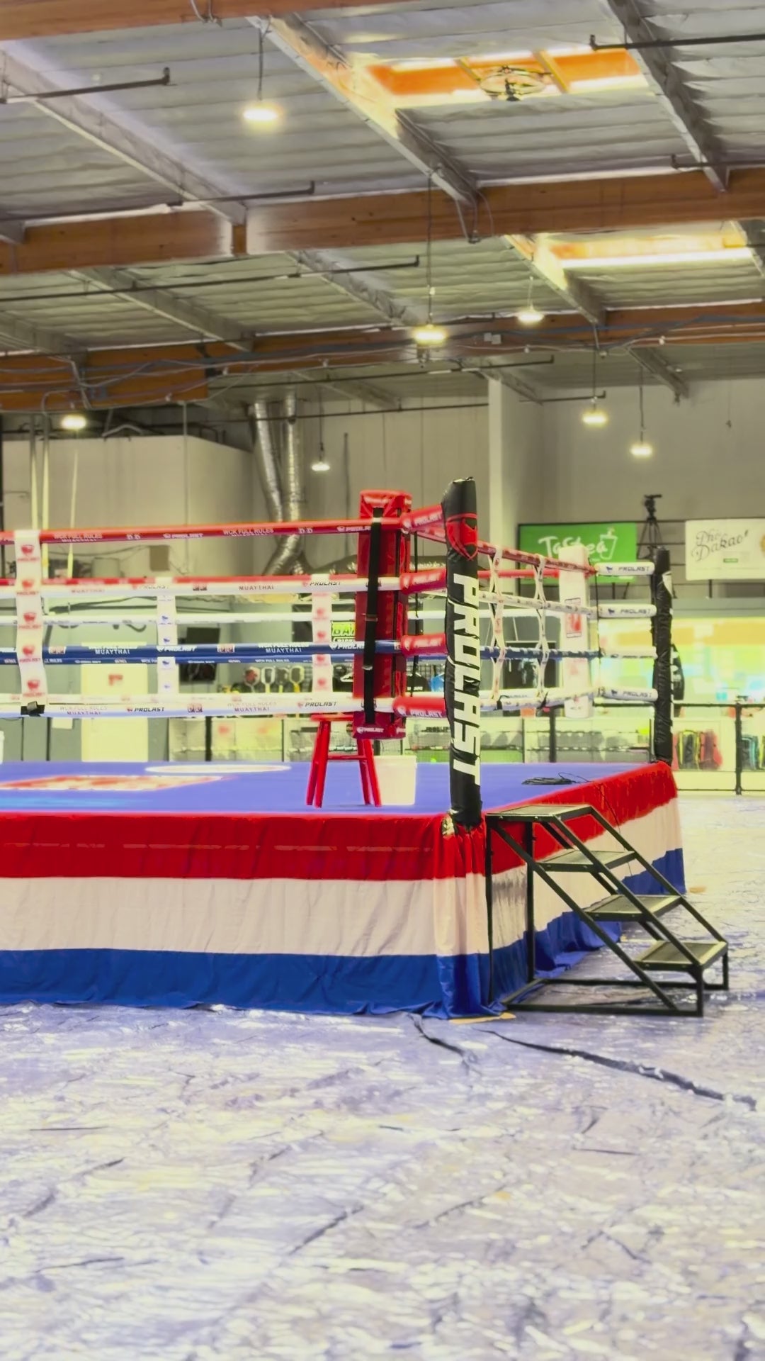 PROLAST boxing ring with a red, white and blue skirt in a warehouse