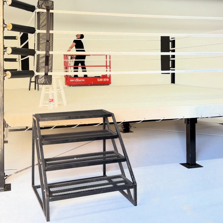PROLAST boxing ring with steel stairs being set up in a white studio