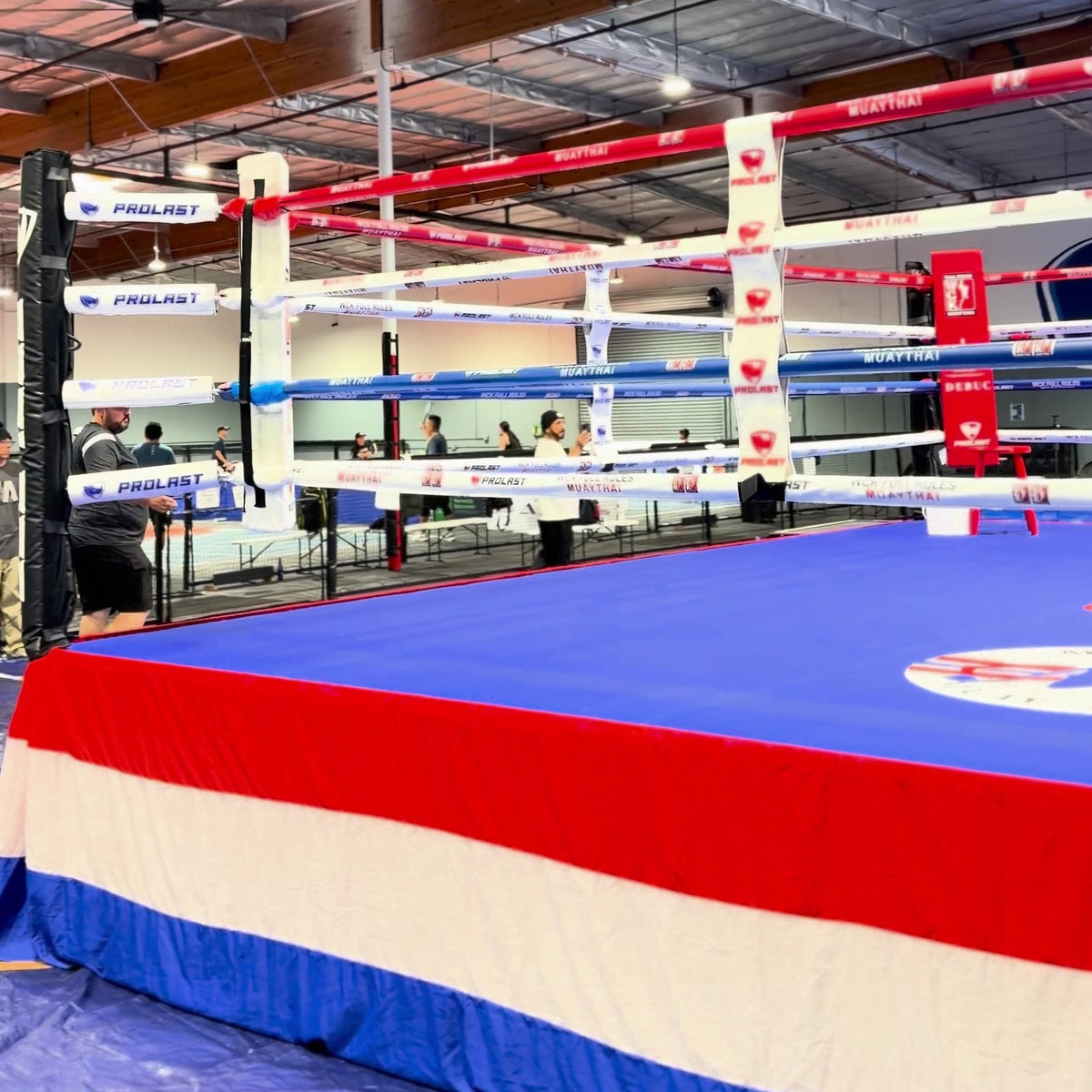 PROLAST boxing ring with a red, white and blue skirt and a blue canvas
