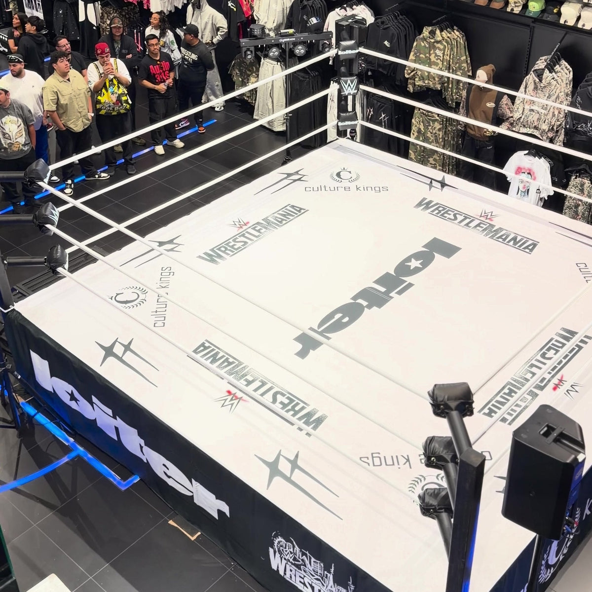 PROLAST boxing ring in a store with a crowd behind it