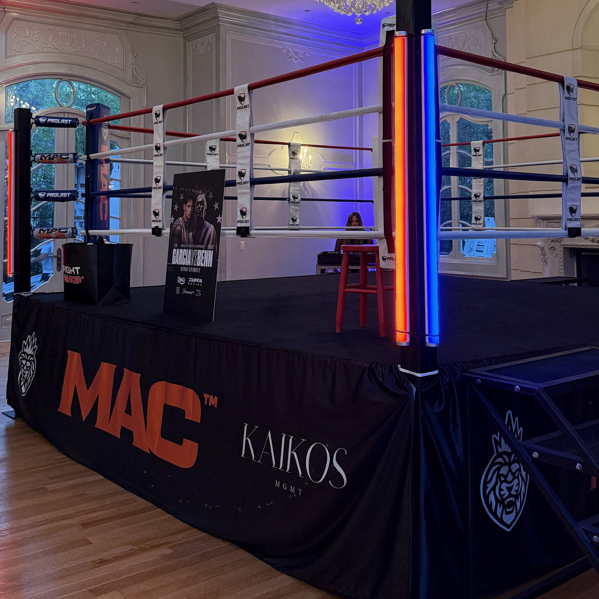 PROLAST boxing ring with red, white and blue ropes in a ballroom, set up for a fight media day
