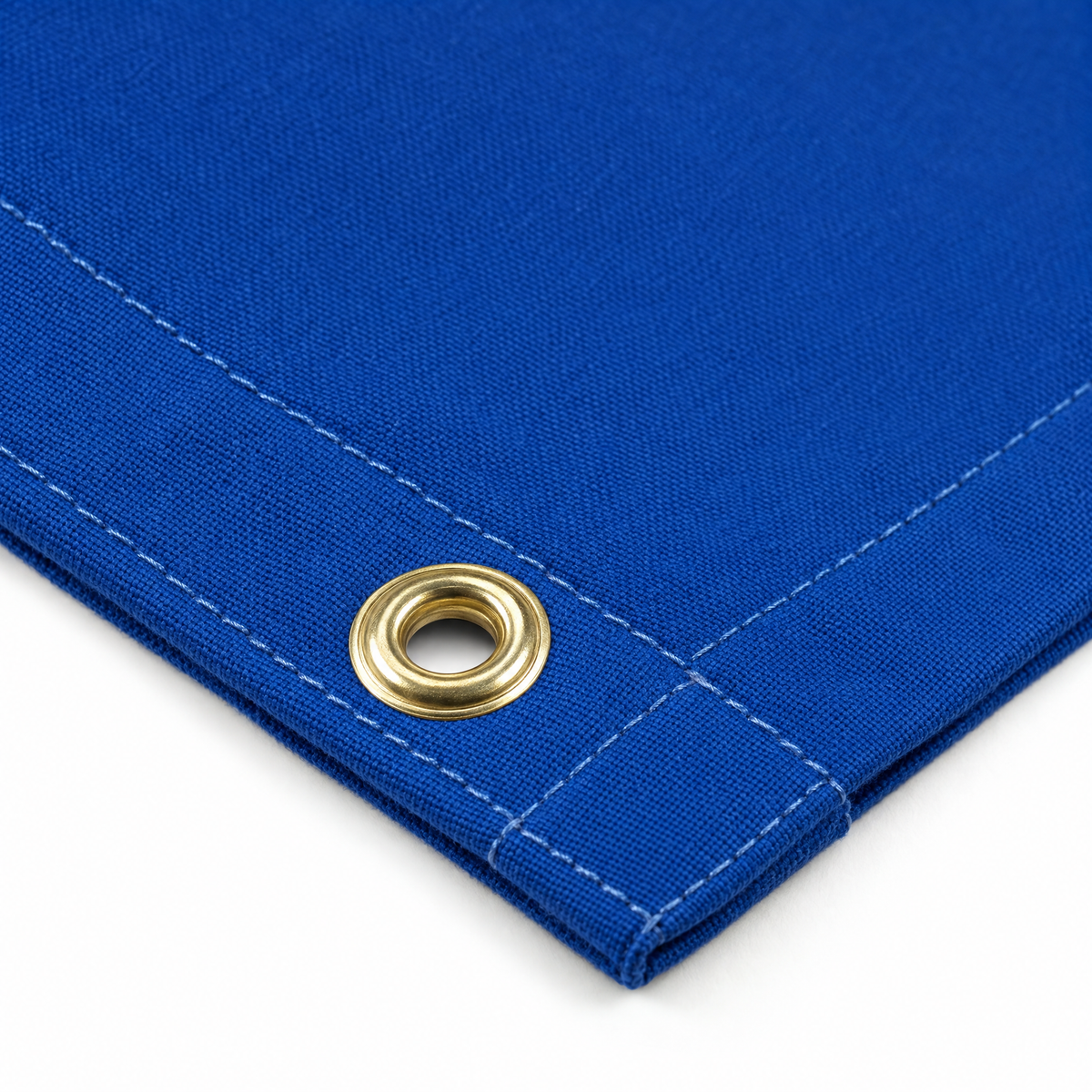PROLAST boxing ring canvas cover close-up: a brass grommet in the double-stitched hem of the blue canvas