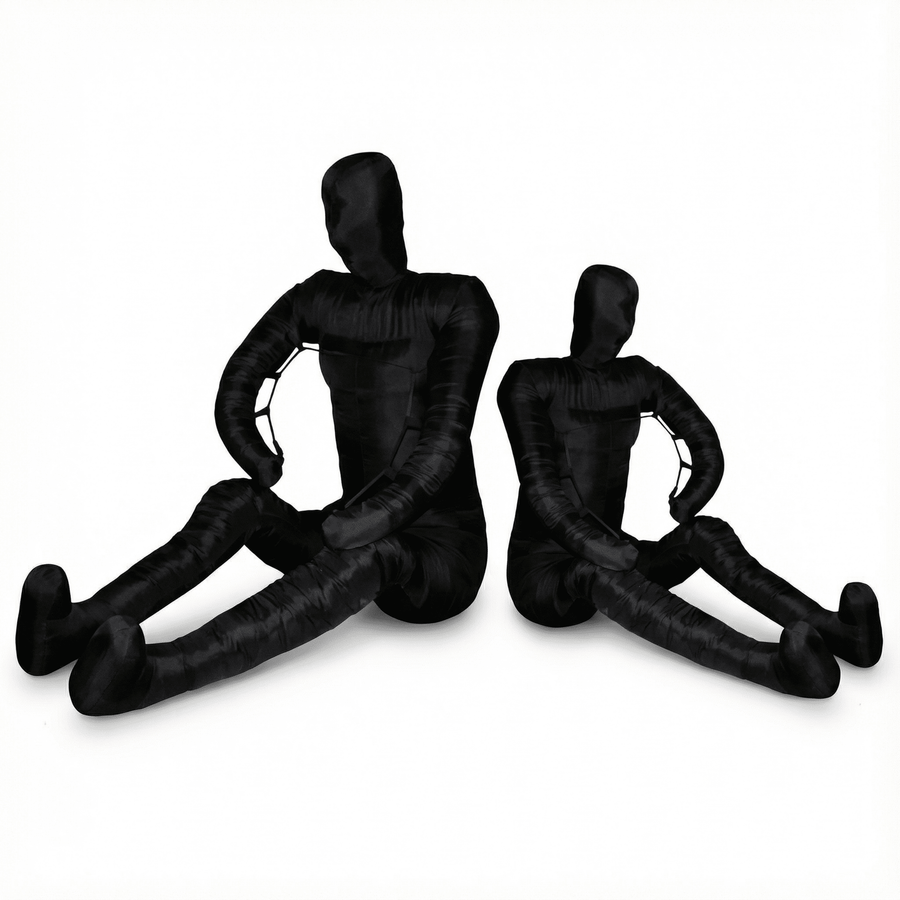PROLAST grappling dummies in black, adult and child sizes seated side by side with legs stretched out