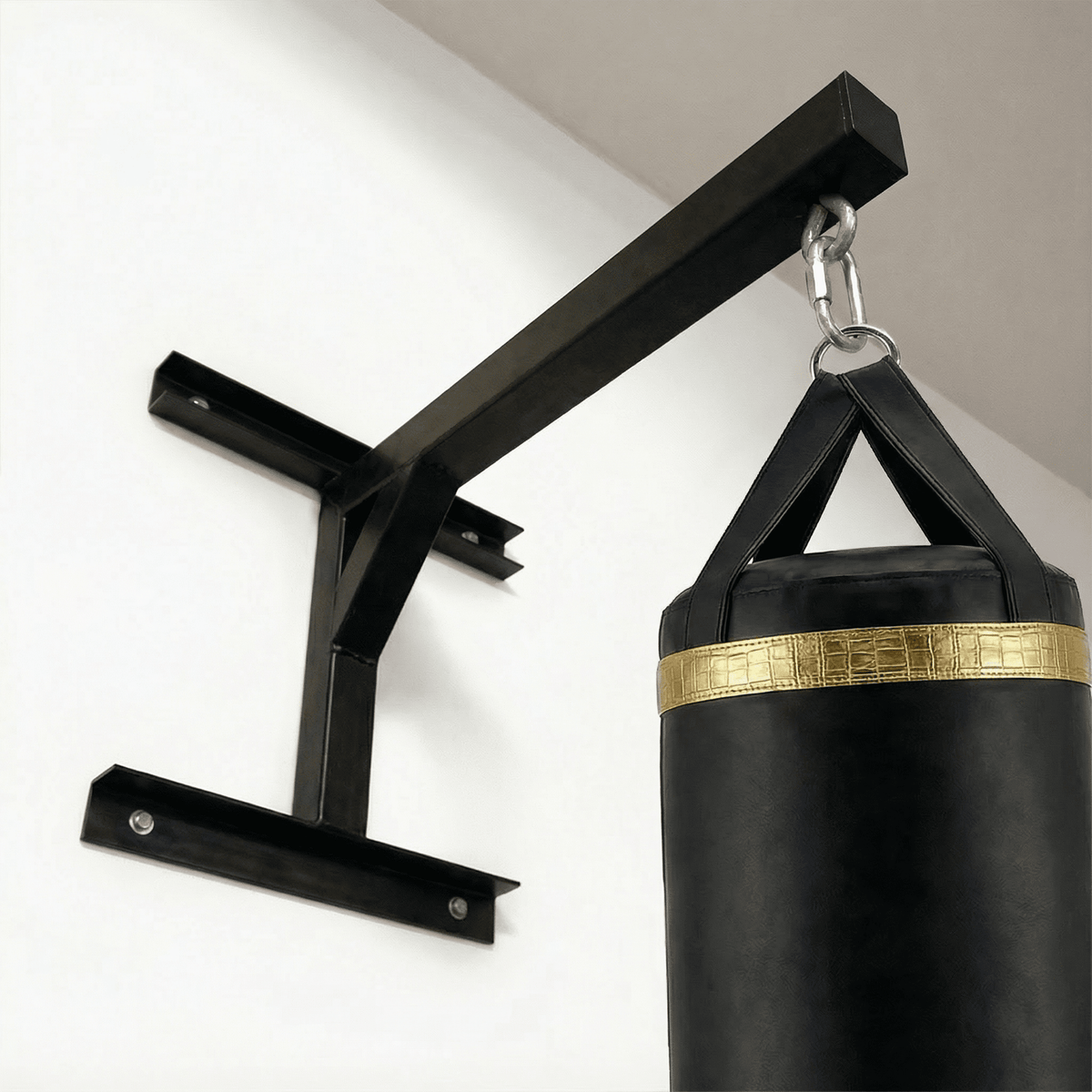 PROLAST heavy bag wall mount fixed to a wall, angled view from below with a black heavy bag hanging on a snap hook