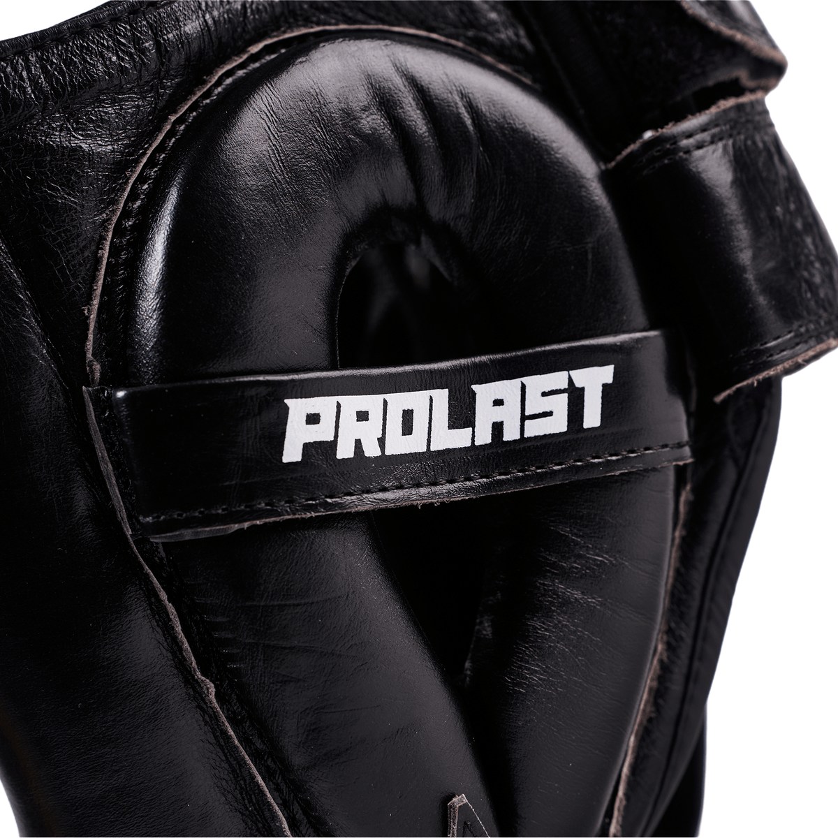 PROLAST nose bar face saver headgear in black, close-up of the padded ear guard with white PROLAST strap