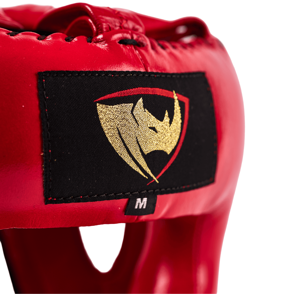 PROLAST nose bar face saver headgear in red, close-up of the gold rhino logo patch and size M tag