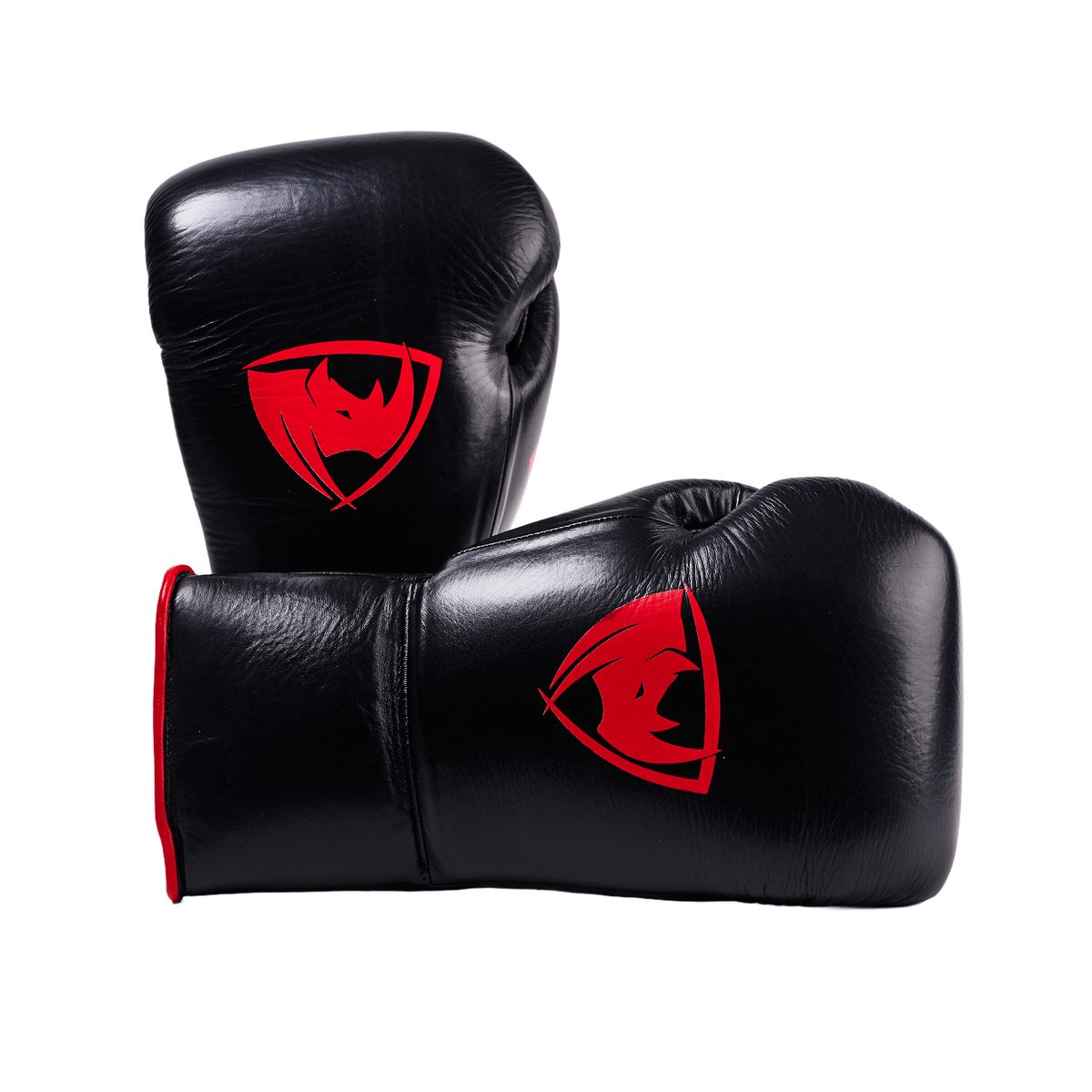 PROLAST PG professional lace-up boxing gloves in black and red, one upright, one lying on its side, both red rhino logos showing