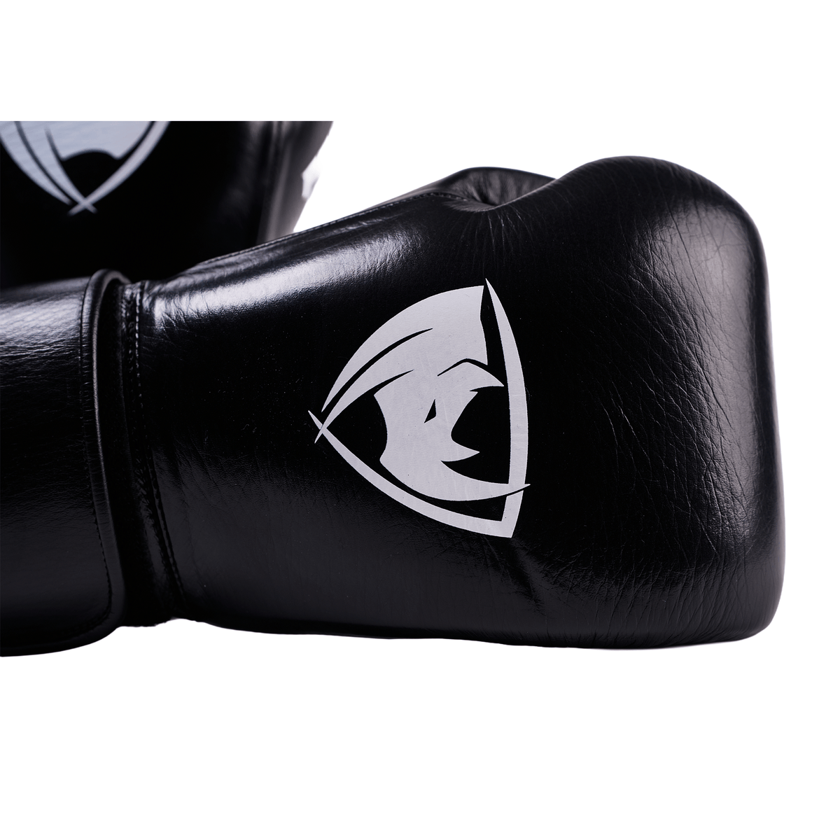 PROLAST PG professional boxing gloves in charcoal black, close-up of the white rhino logo and Velcro wrist strap