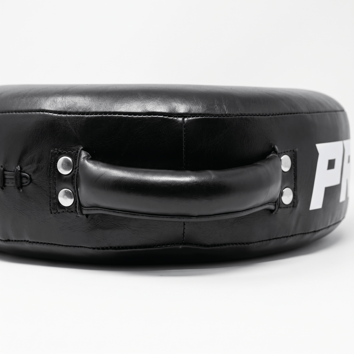 PROLAST round punch shield in black, close-up of a padded handle riveted to the rim