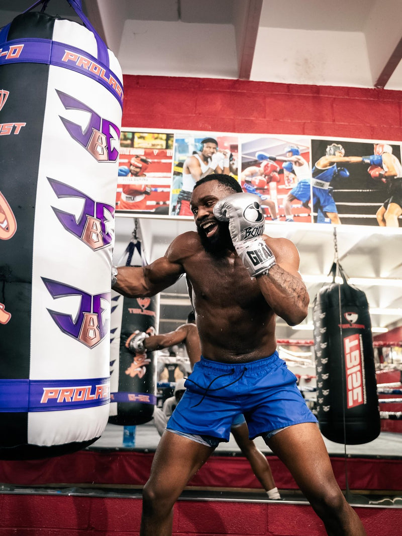 Jaron “Boots” Ennis training on his custom purple and white JBE heavy bag, made by PROLAST